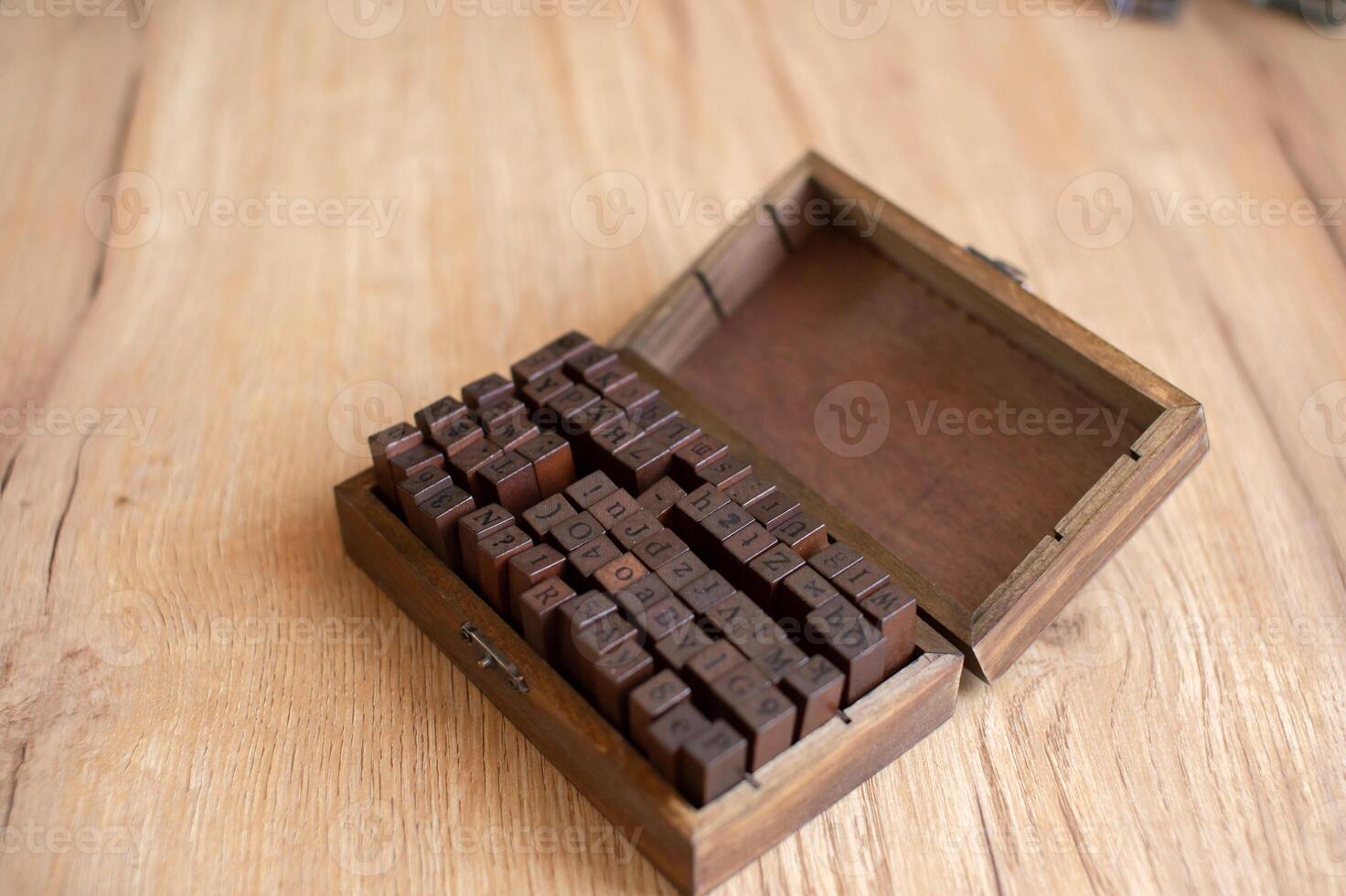 Vintage Wooden Letterpress Blocks in Rustic Box on Table. photo
