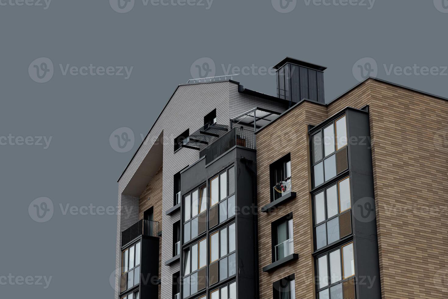 Architecture of modern apartment building. Urban residential structure with wooden facade, balcony, photo