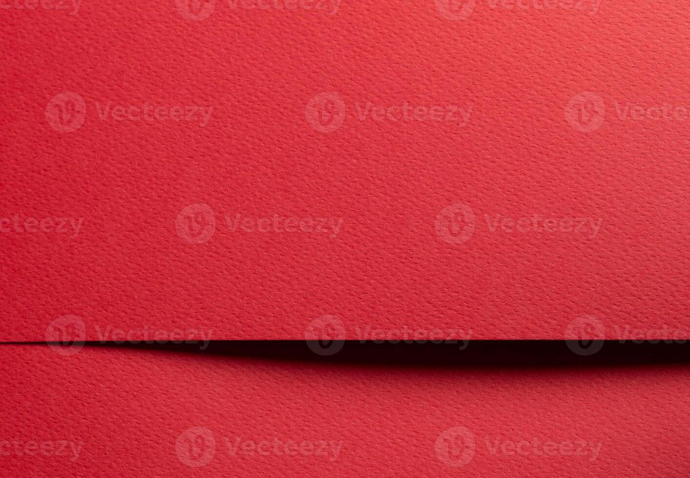 Elegant red paper sheet with smooth matte texture. Bright, festive background with minimalistic photo