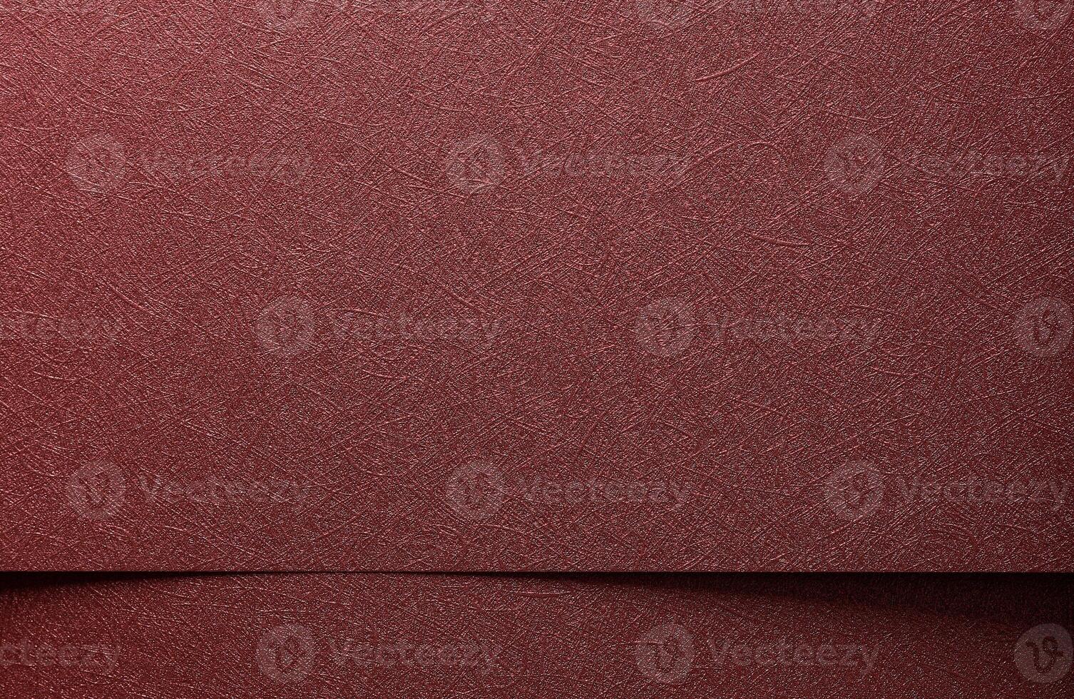 Metallic paper background closeup. Monochrome red and marsala sheets with shiny gradient, glossy photo