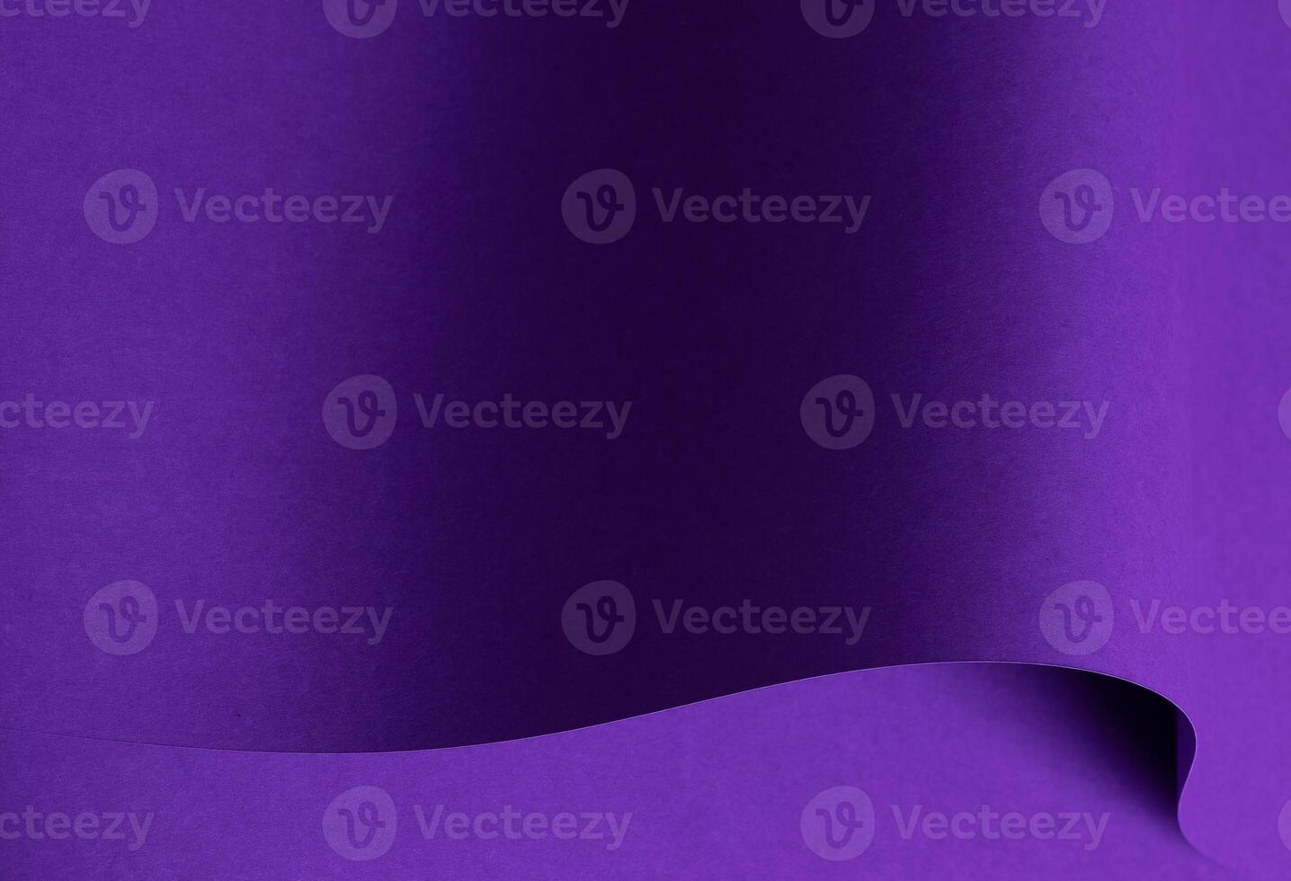 Designer paper in bright and dark violet purple tones with wavy folds and curved shapes. Matte photo