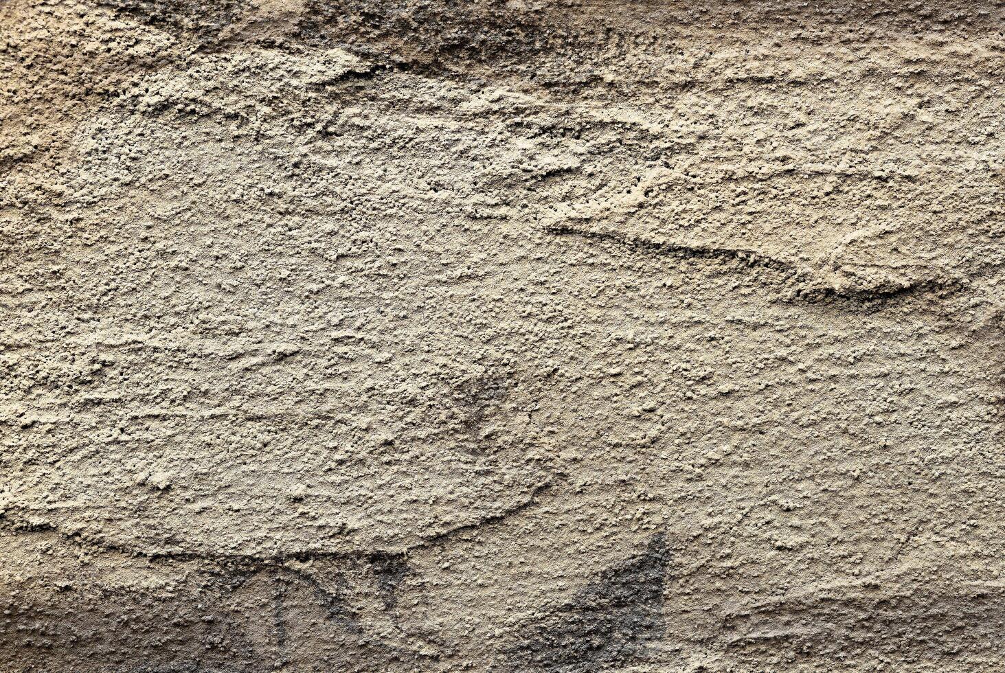 Golden textured wall with rough, grungy surface and antique pattern. Aged, weathered metal or stone photo