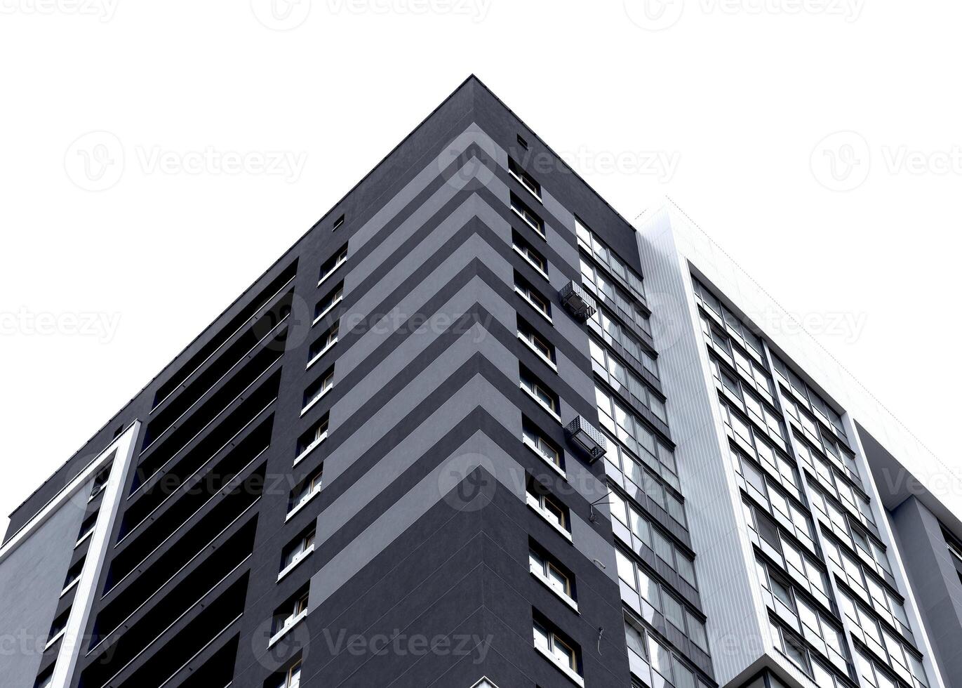 Building corner with modern high rise apartment architecture. Tall white residential structure with photo