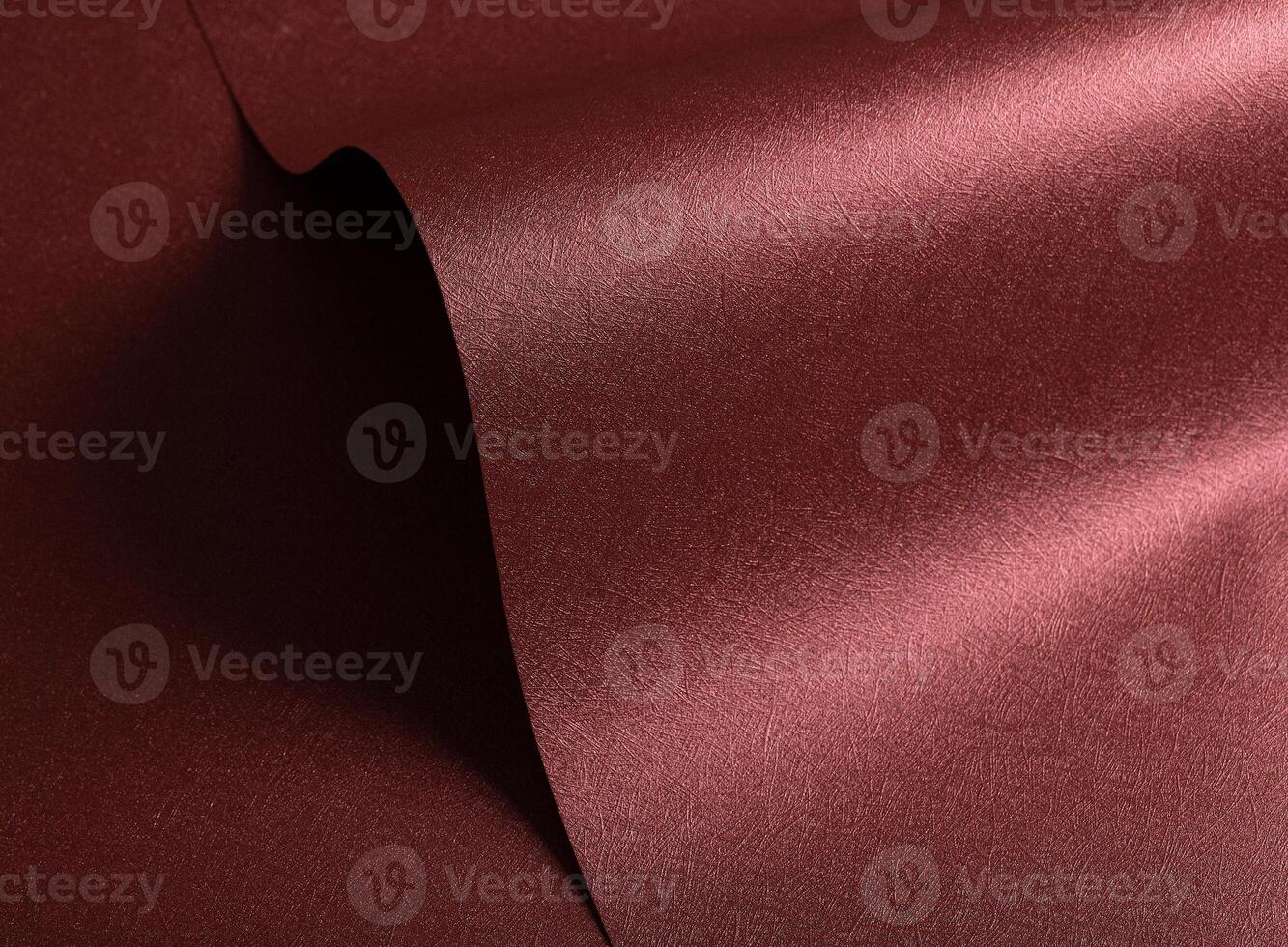 Designer paper closeup. Minimalistic red and marsala surface with pearlescent gloss, wavy folds, photo