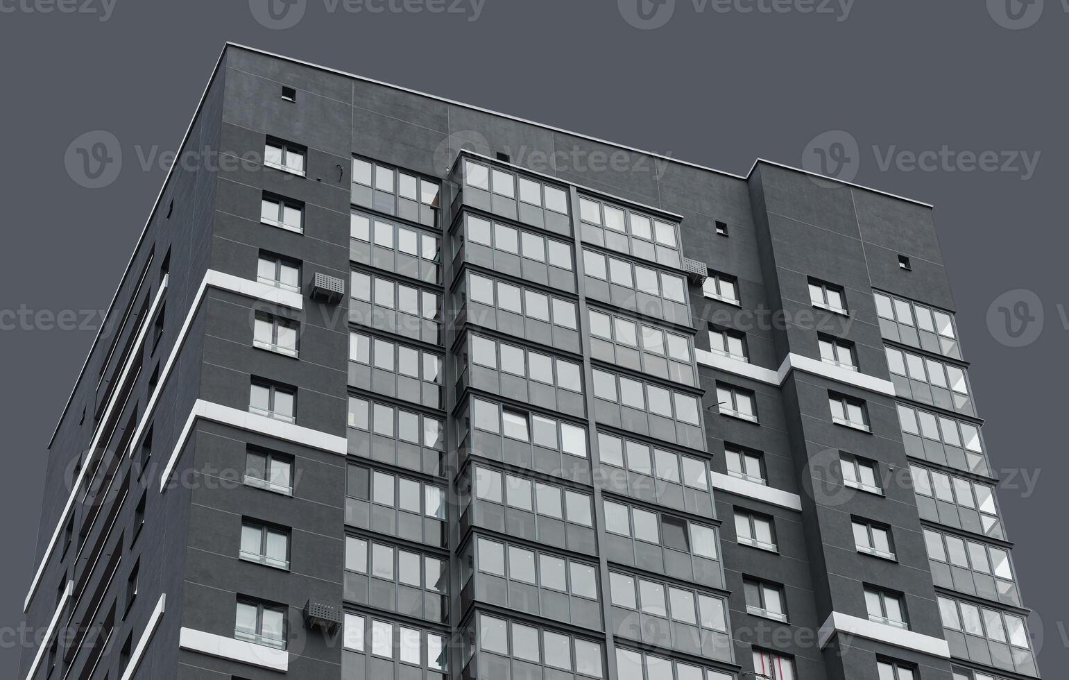 Building with modern architecture. High rise residential tower with geometric concrete facade, photo