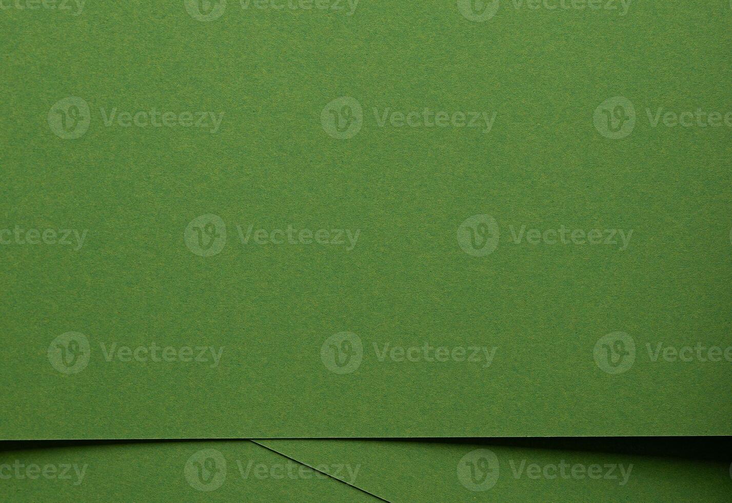 Monochrome green paper texture. Matte surface with smooth fiber detail, geometric overlap of organic photo