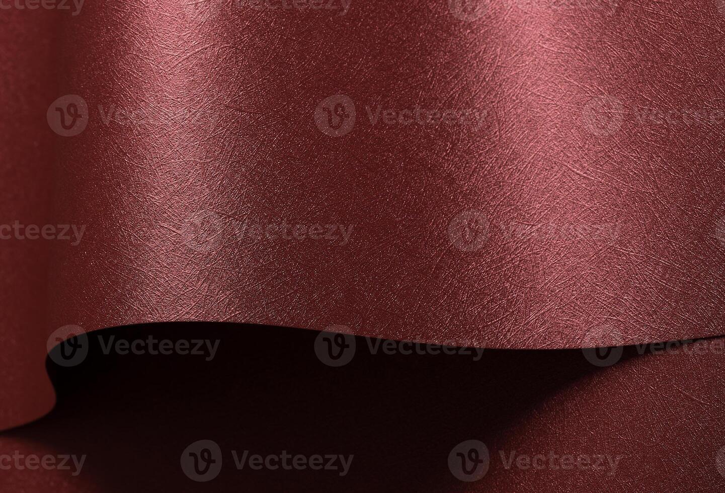 Chic paper background in red and marsala. Pearlescent metallic surface with glossy folds, wavy photo