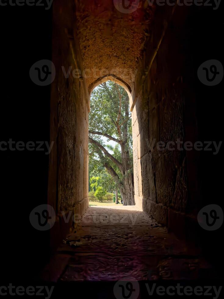 Window arch with stone frame, creating a narrow passage between light and shadow. Historic, photo
