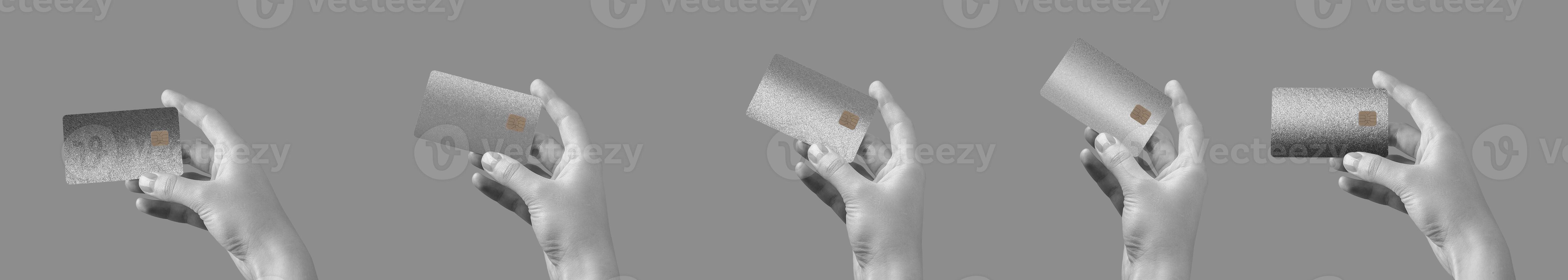 A hand holding a premium credit card, showcasing secure, cashless payment. Elegant gray and black photo