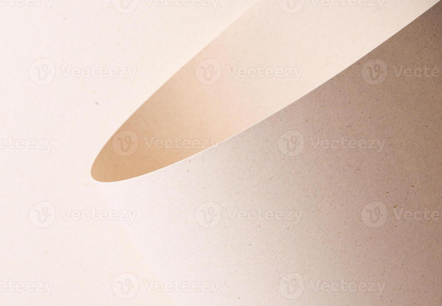 Curved sheet of elegant designer paper in creamy beige tones with tactile porous texture and organic photo