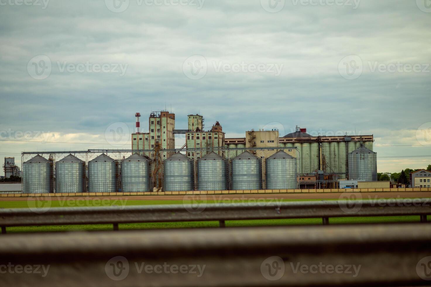 A large building with many silos in the background photo