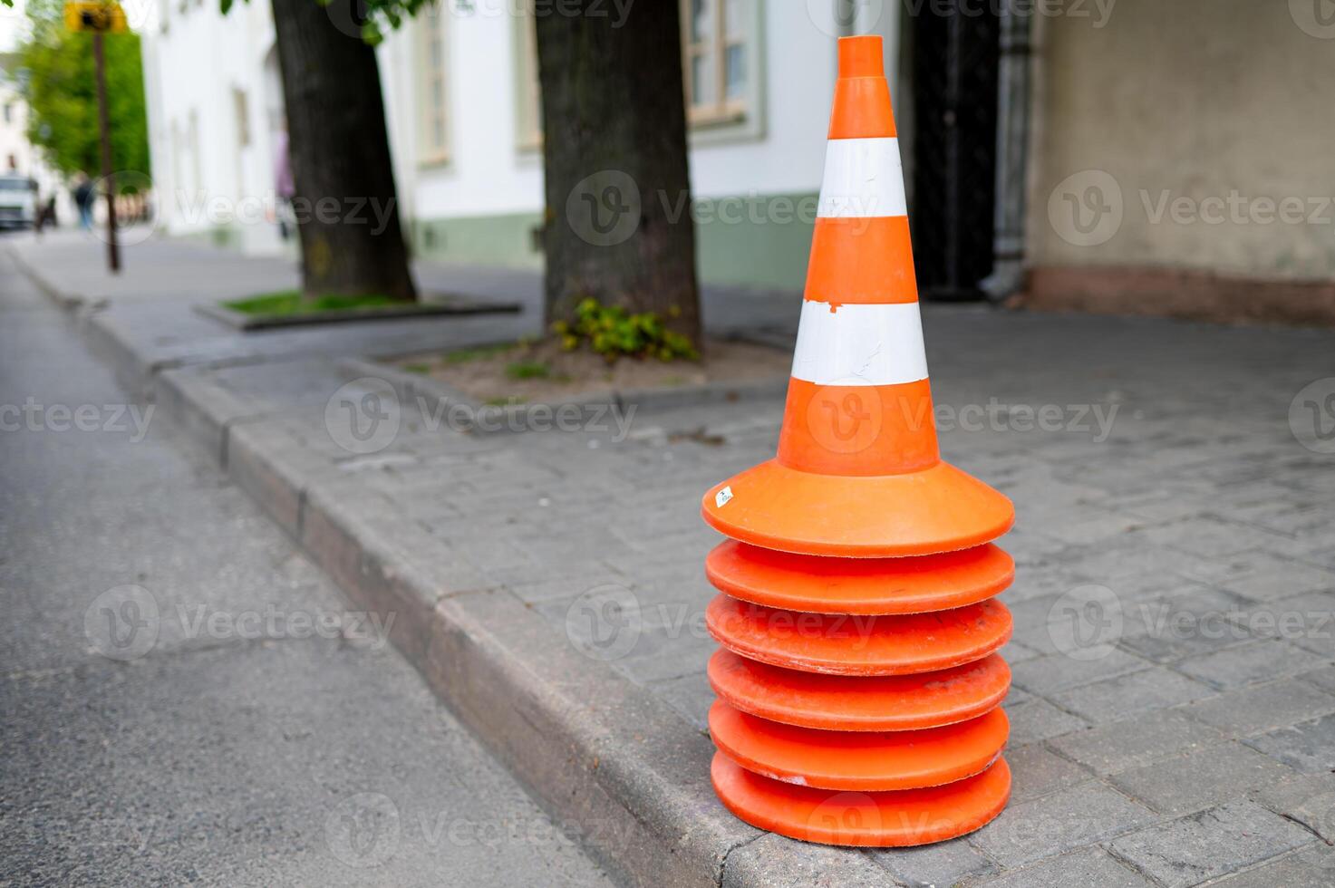 A traffic cone on the side of the road photo