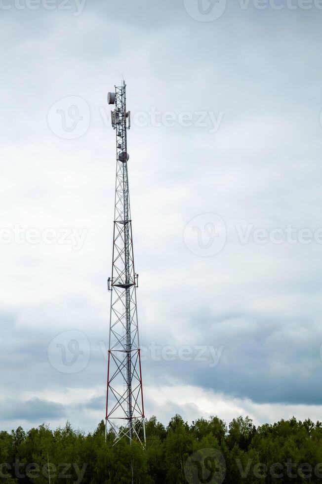 A cell phone tower in the middle of a field photo