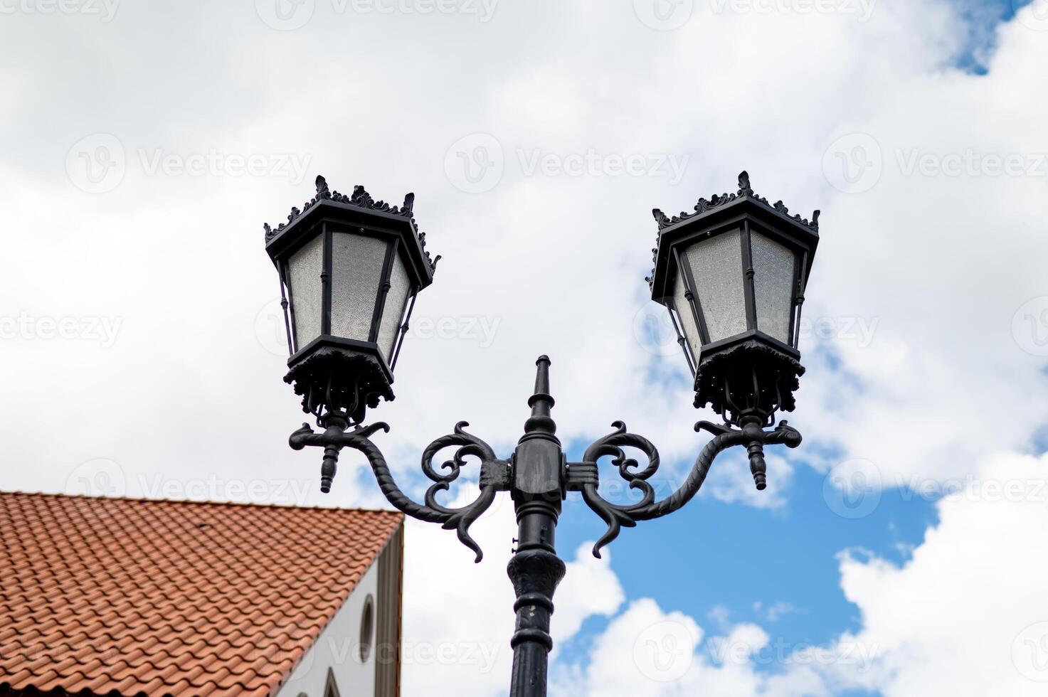Two street lamps on a pole photo