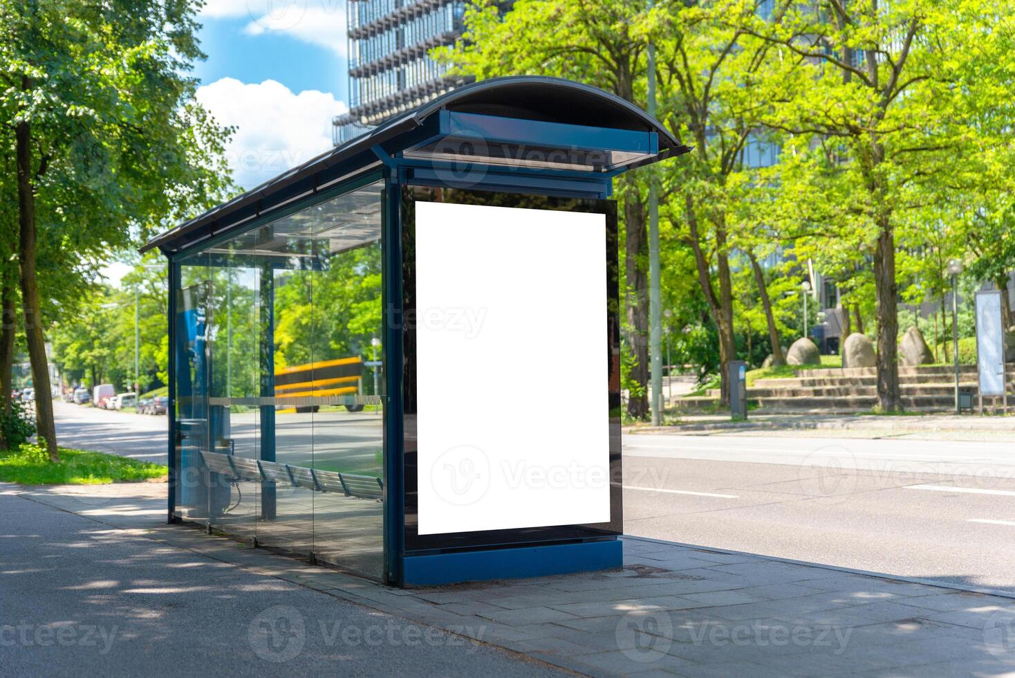 Blank bus stop mockup in sunny urban environment with green trees, ideal for outdoor advertising or city branding campaigns photo