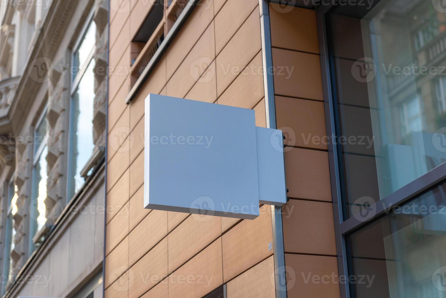 Modern blue square signage mounted on sleek facade, perfect for contemporary store branding, tech visuals, or corporate identity mockups photo