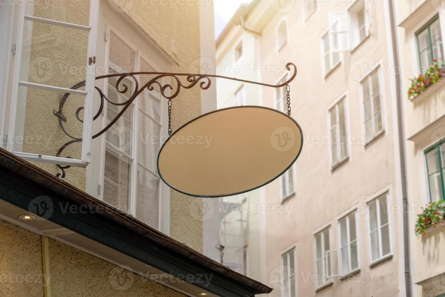 Retro style empty signage board with wrought iron support, ideal for traditional business mockups, bakery or local artisan shop branding. photo