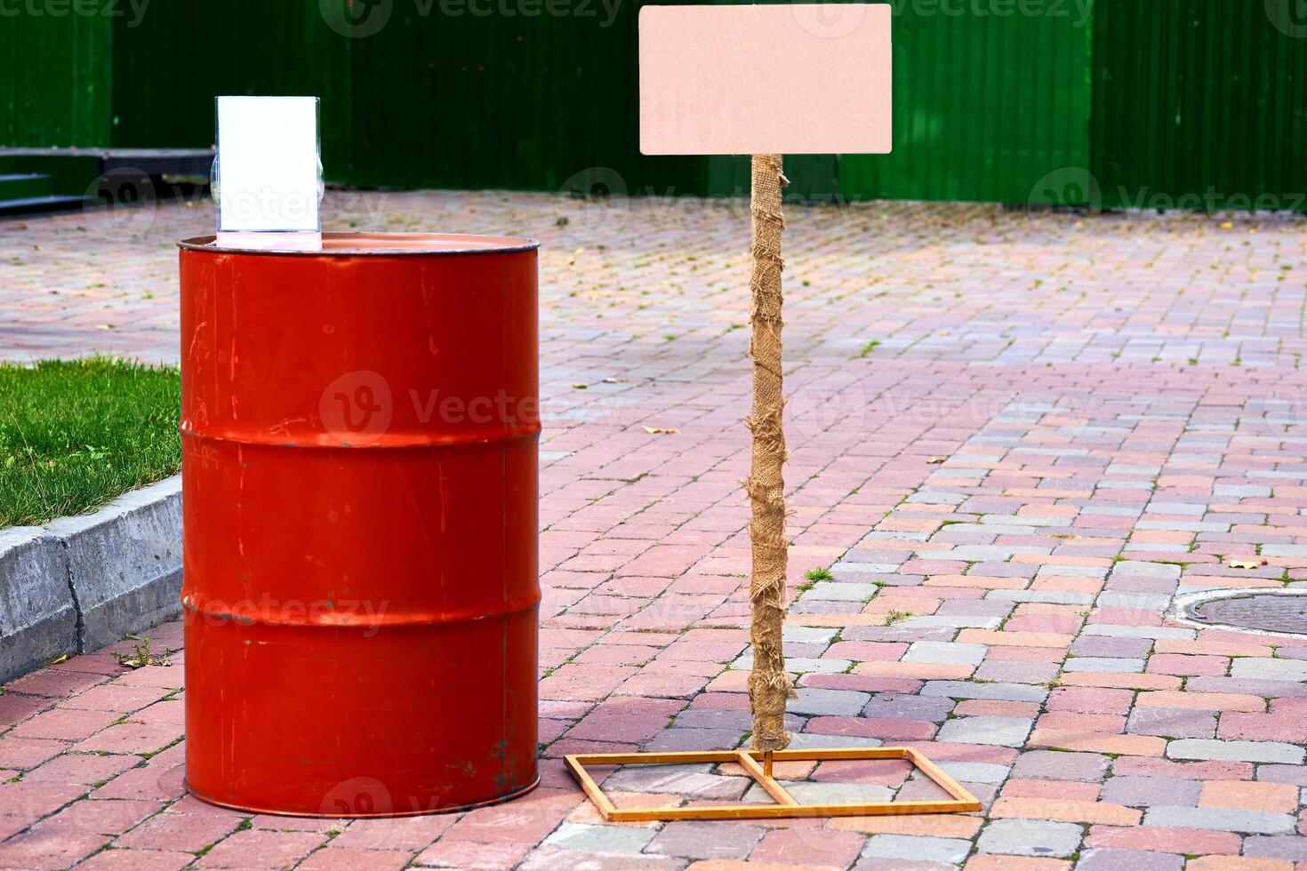 Red iron barrel for fuel, lubricating oil in front with frames photo