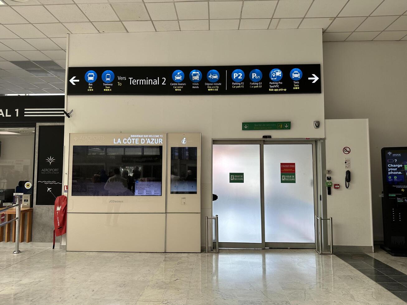 Nice, France - May 10, 2025 Airport terminal signage directing travelers to Terminal 2 with information displays and modern design elements showcasing travel convenience and accessibility photo