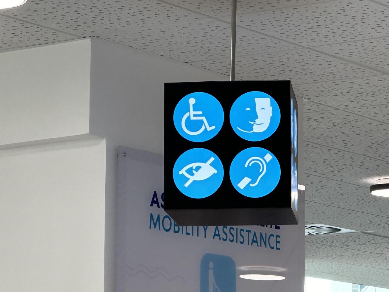 Nice, France - May 10, 2025 Signage displaying mobility assistance icons for accessibility, featuring wheelchair, hearing aid, and other support symbols in a modern facility photo