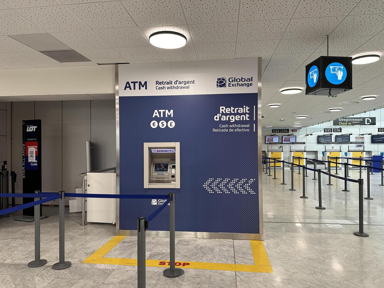 Nice, France - May 10, 2025 ATM cash withdrawal station located in an airport terminal, featuring clear signage and a queue area for travelers needing currency exchange services photo