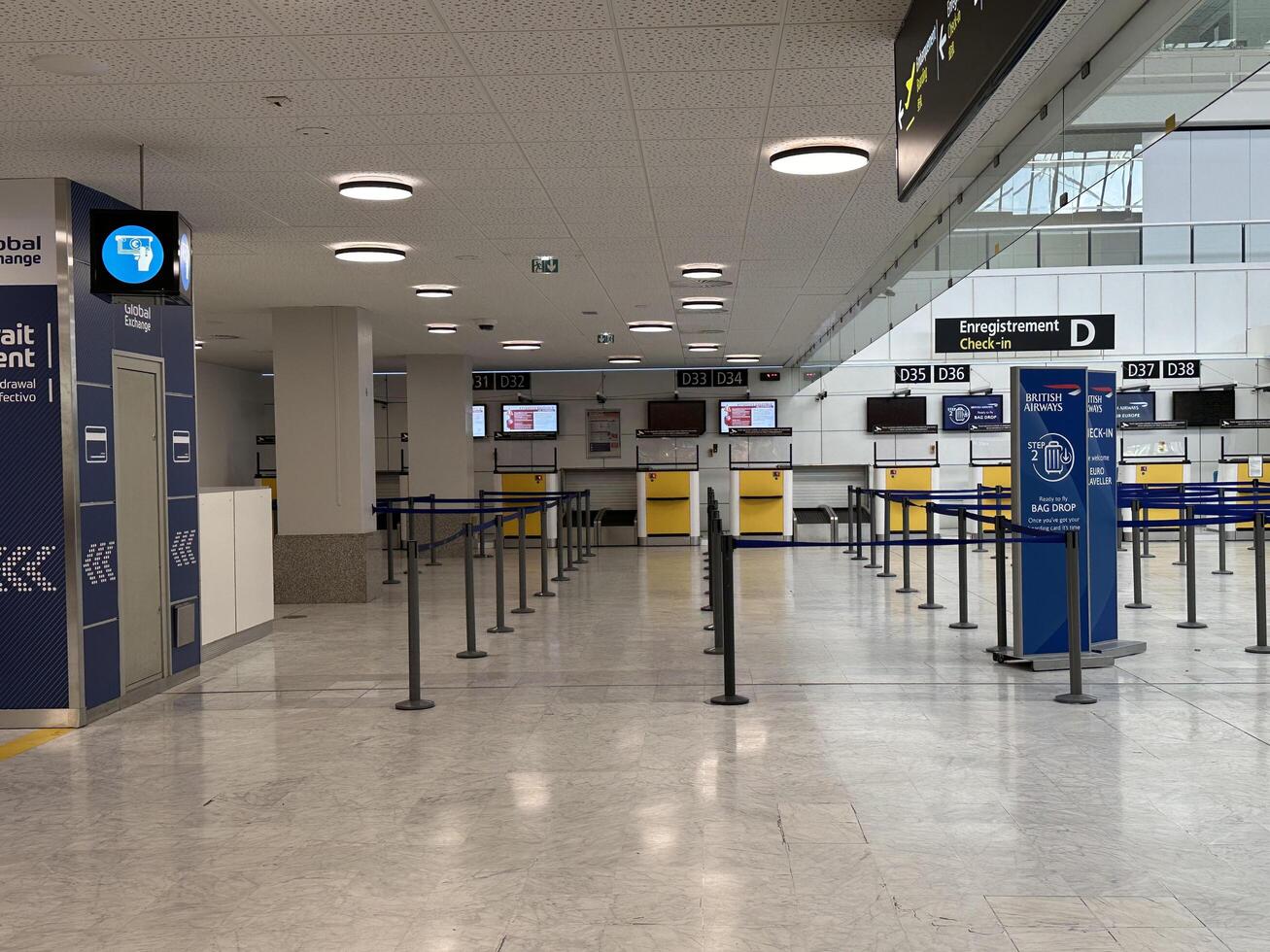 Nice, France - May 10, 2025 Airport terminal interior with empty check-in counters and signage, showcasing modern design and spacious layout with copy space for travel-related content photo