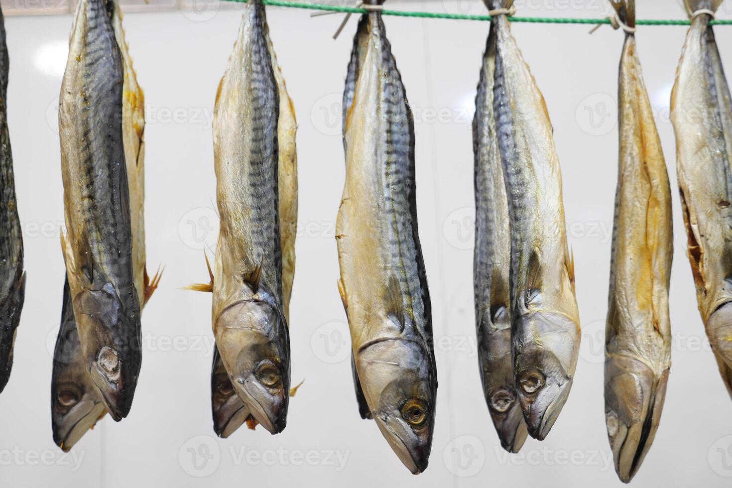 Hanging dried fish displayed at a local market in summer photo