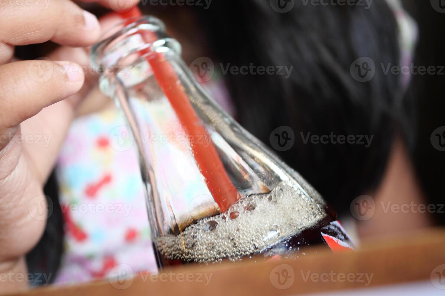 Child Enjoying a fizzy drink at a casual setting photo