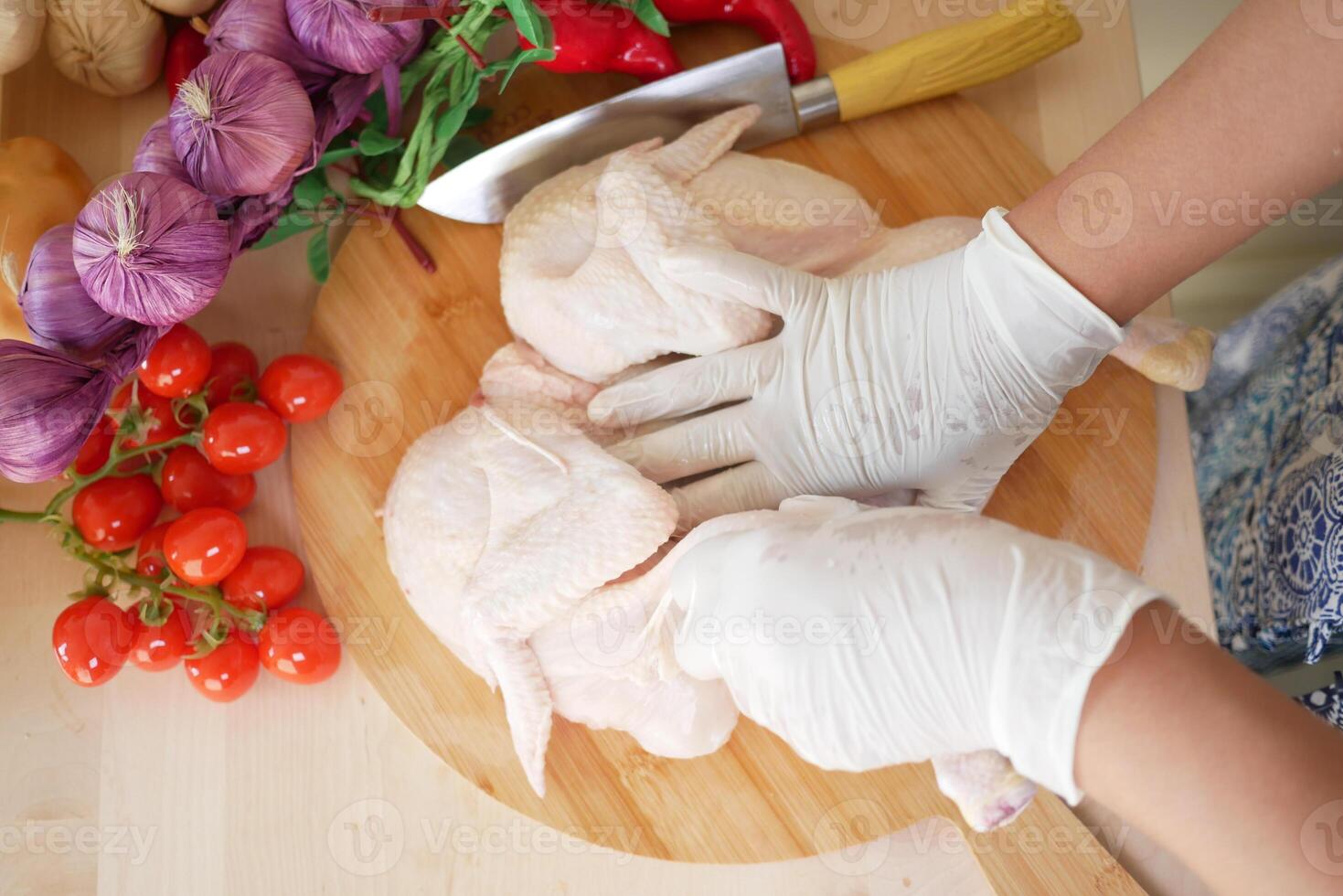 Preparing chicken with fresh vegetables in a kitchen photo