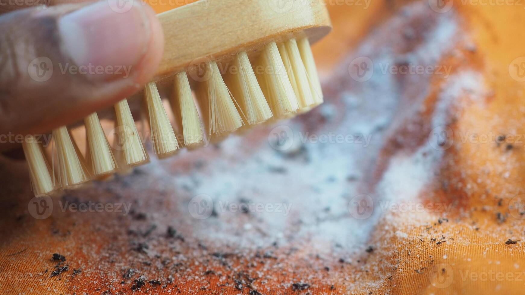 Cleaning a cloth with a brush and baking soda photo