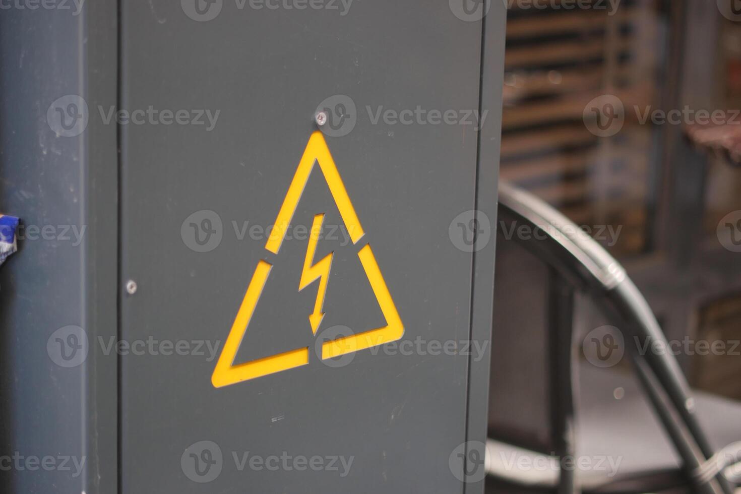 Warning sign on electrical cabinet in industrial location photo