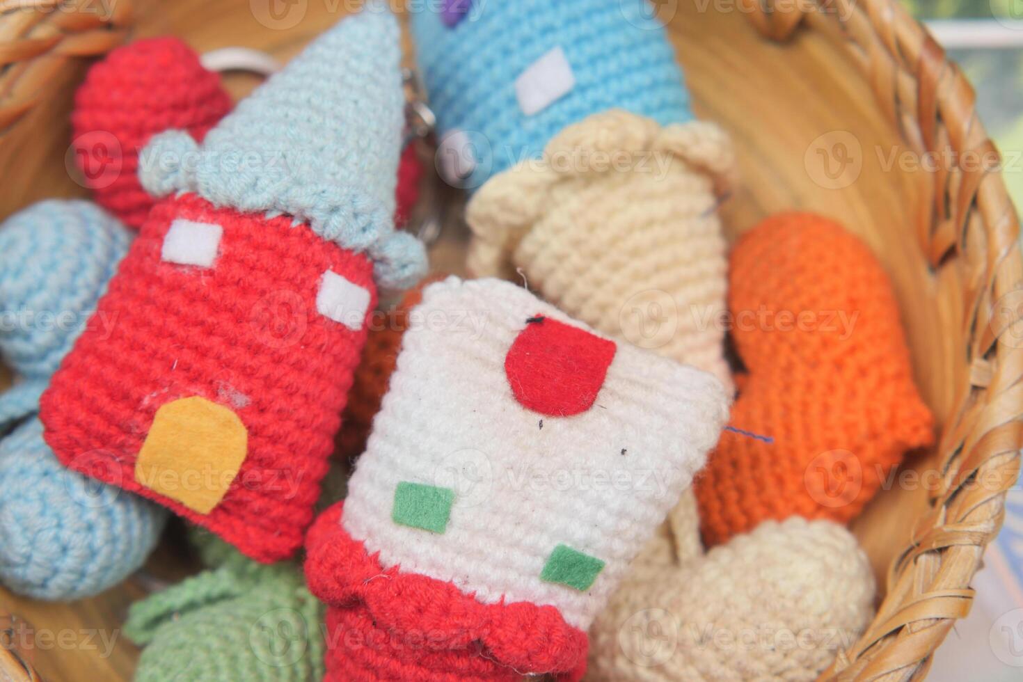 Colorful handmade keychains in a woven basket display photo