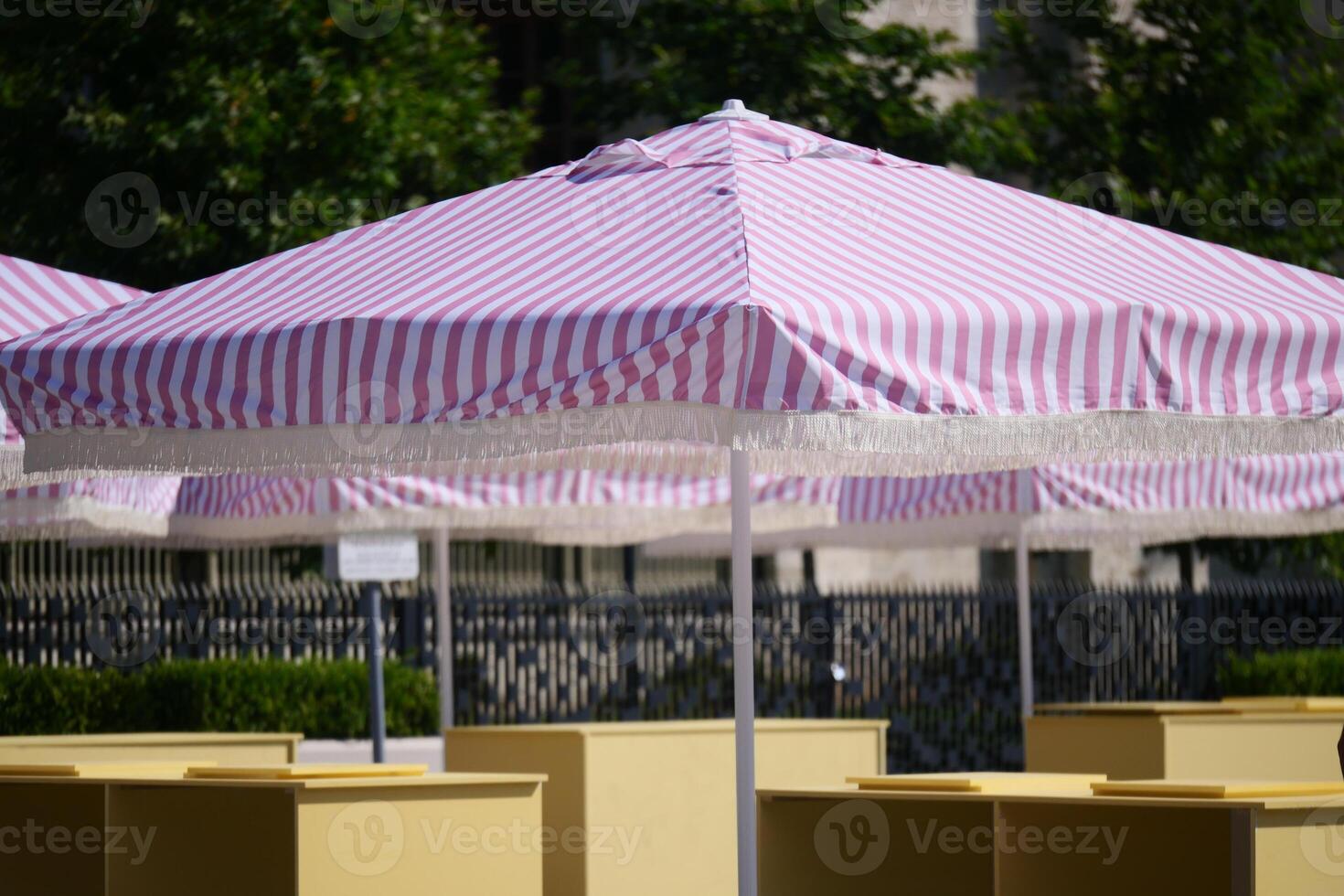 Colorful striped umbrellas set up in an outdoor space photo