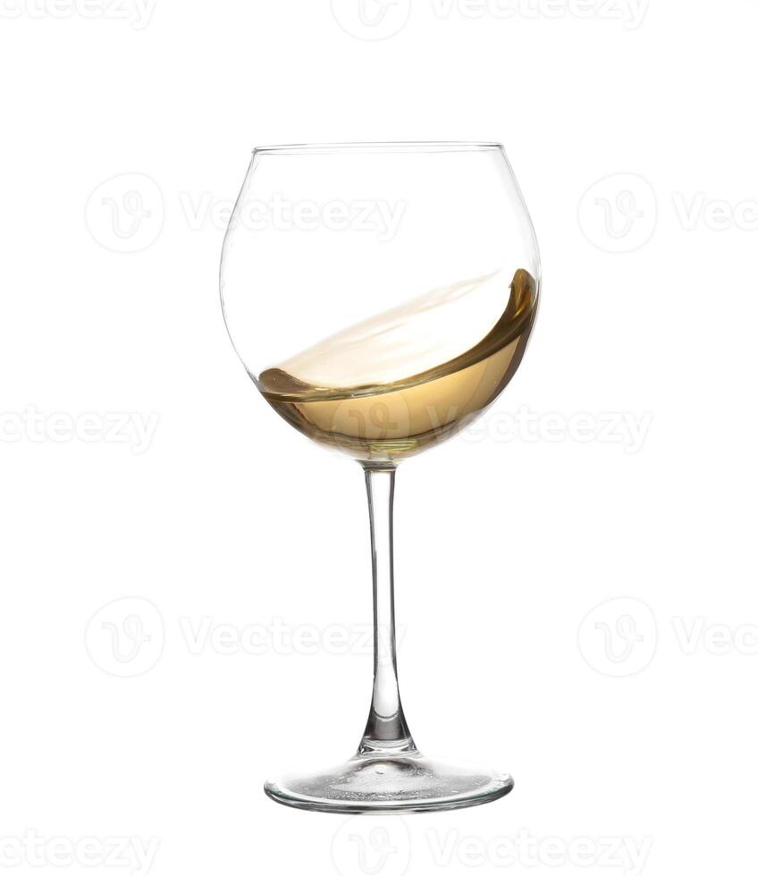 wine glass with a white wine liquid inside photo