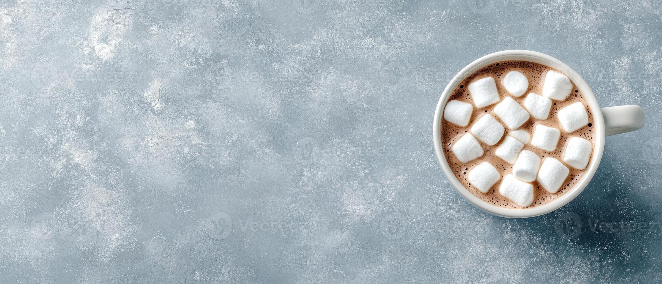 Cup with low carb dessert on grey surface. Gluten free sweet drink with white marshmallows. Delicious and diet dessert on background. photo