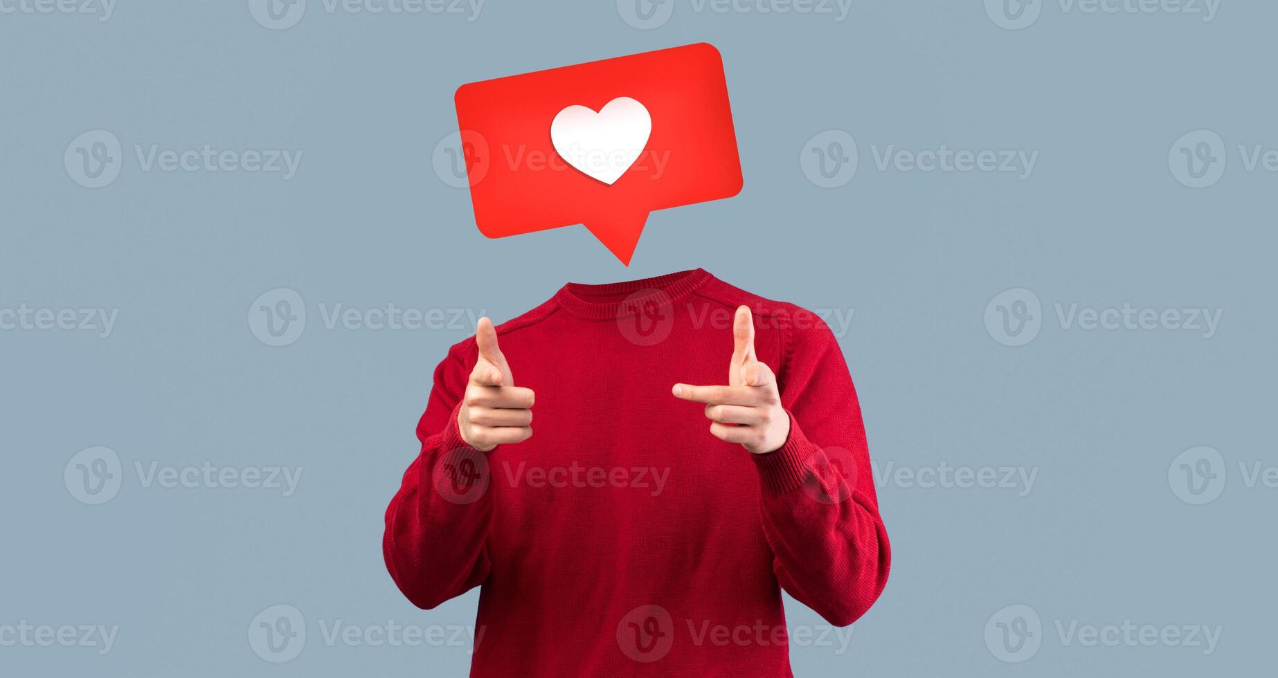 A person in a red sweater gestures playfully while displaying a heart icon instead of their head, symbolizing social media engagement and connection. The backdrop is minimal and modern. photo