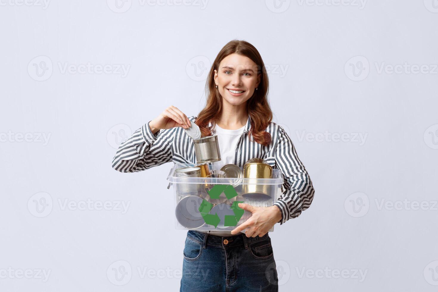 Metal Recycling. Young Smiling Woman Holding Plastic Container Box With Tin Cans, Eco Volunteer Enjoying Garbage Recycling And Zero Waste, Standing Over Light Studio Background, Copy Space photo