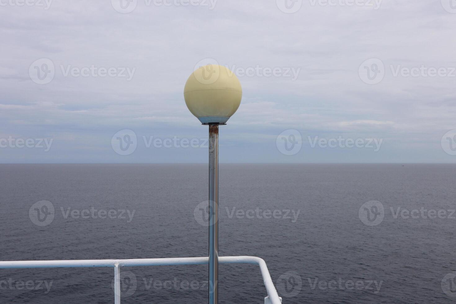A light pole on a boat with a yellow light on it photo