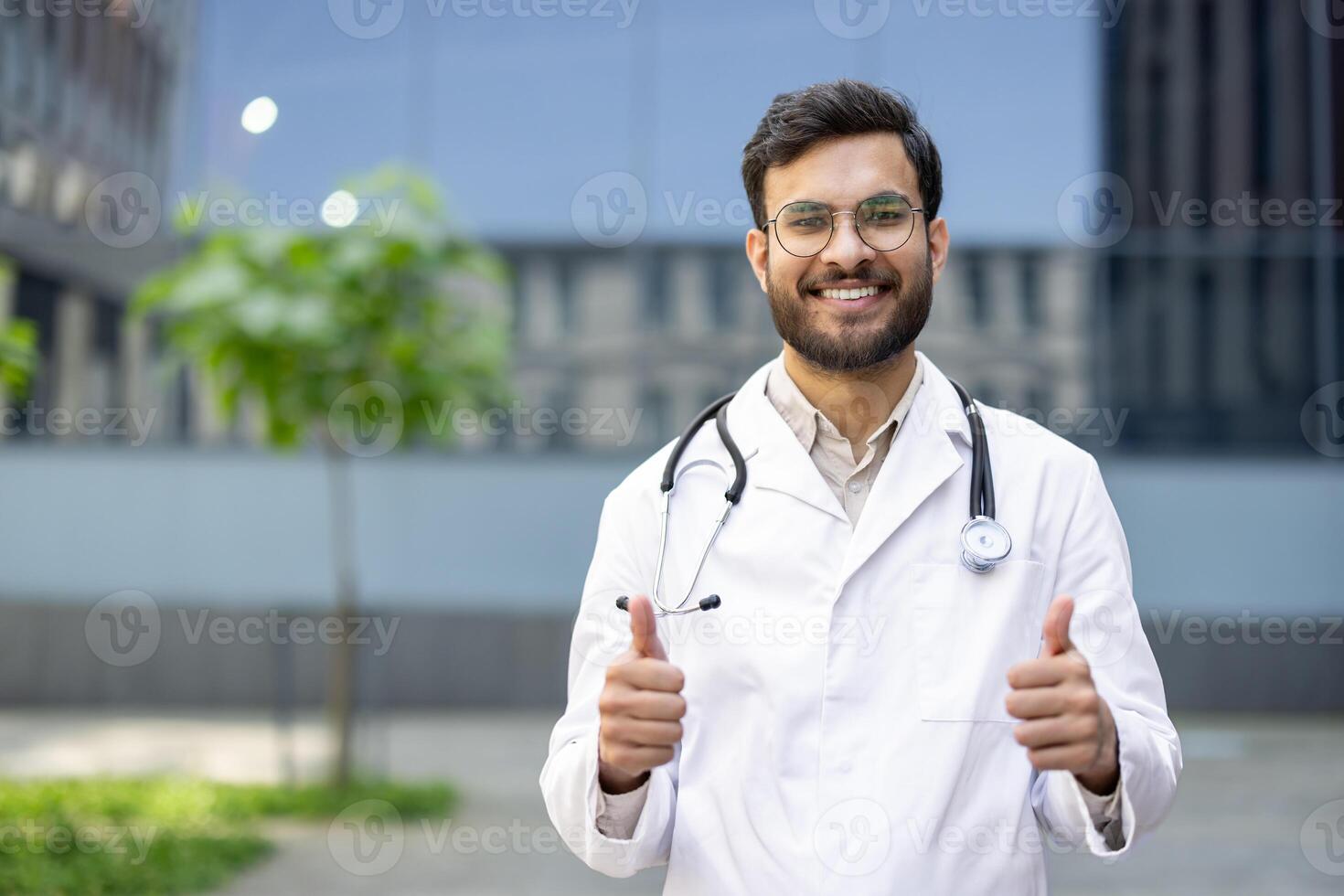 A smiling doctor with glasses gives a thumbs-up, showcasing positivity and approval, ideal for medical and healthcare concepts. photo