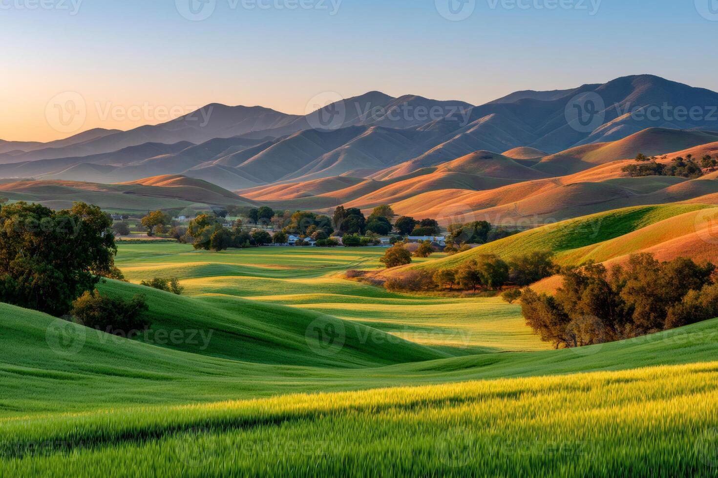 Rolling green hills and mountains at sunset in california countryside photo