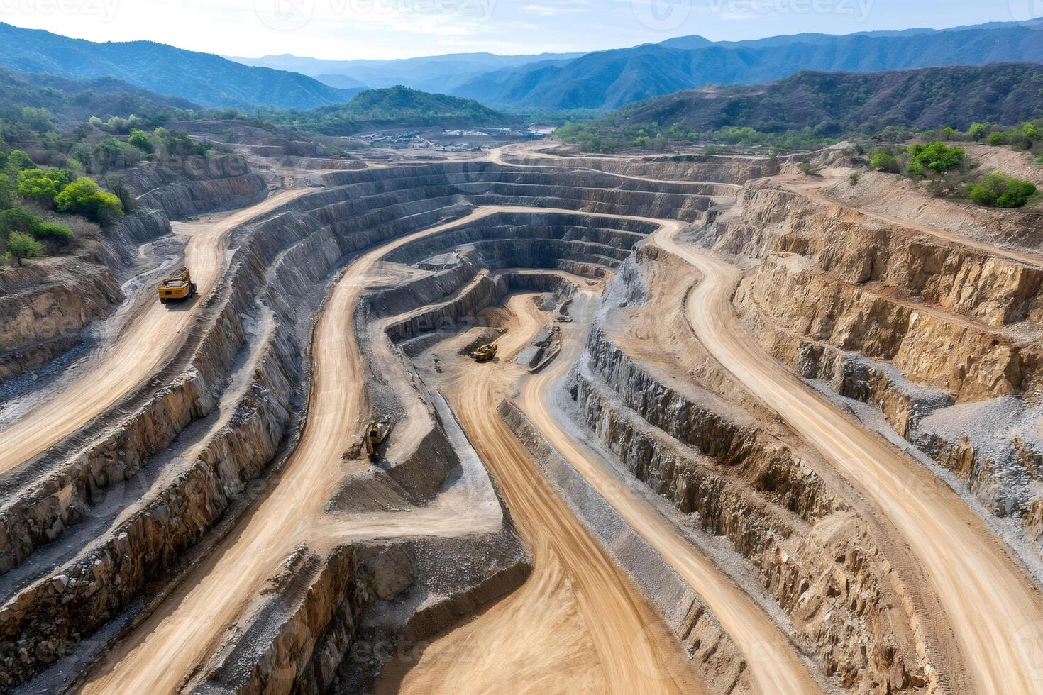 Open pit mine showing switchback roads for heavy trucks descending photo