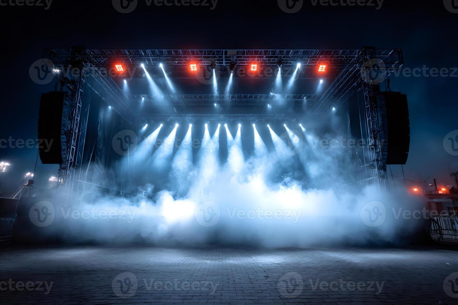 Empty stage with spotlights and smoke illuminating night sky photo