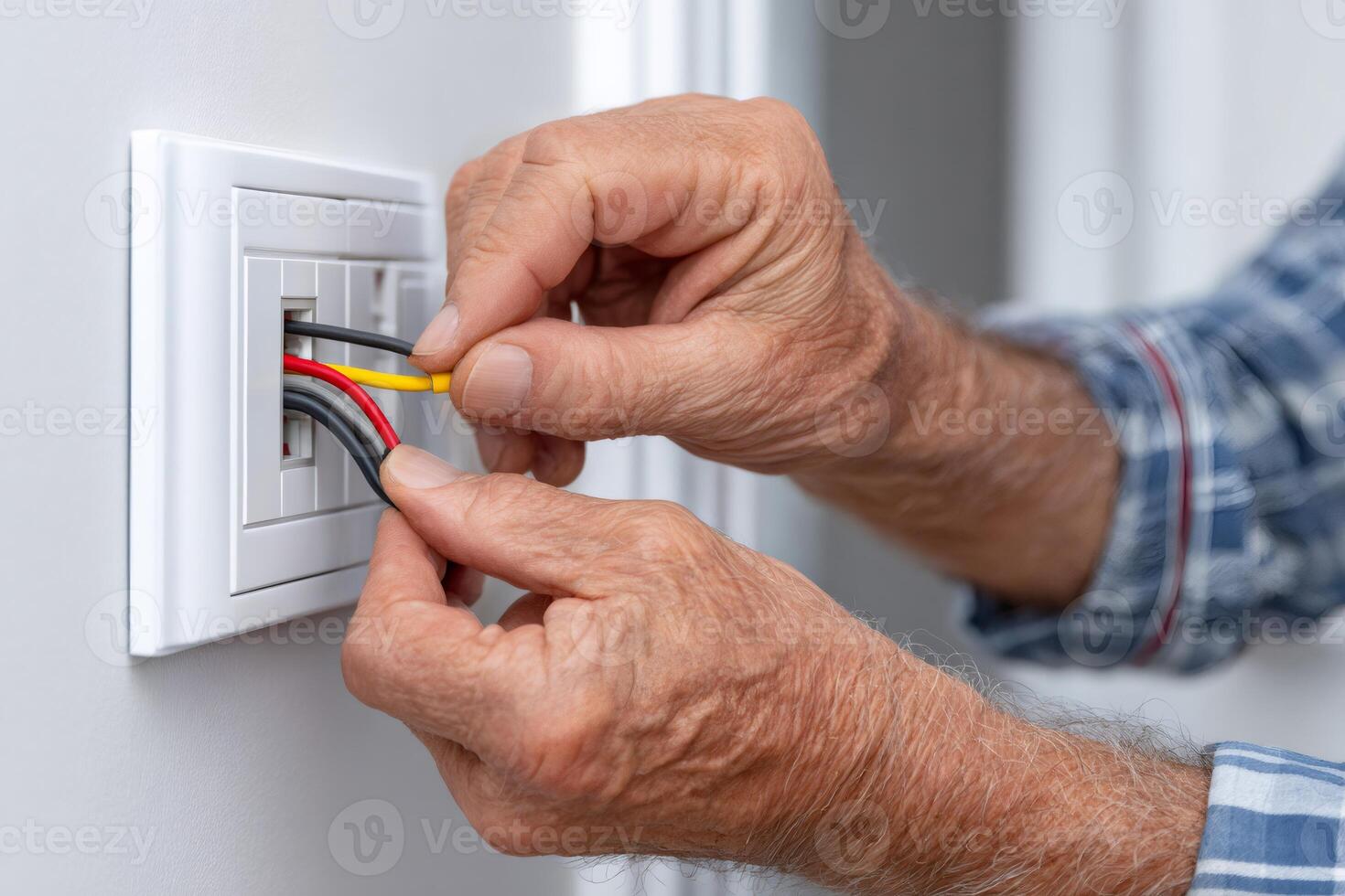 Electrician installing cable in a network wall socket photo
