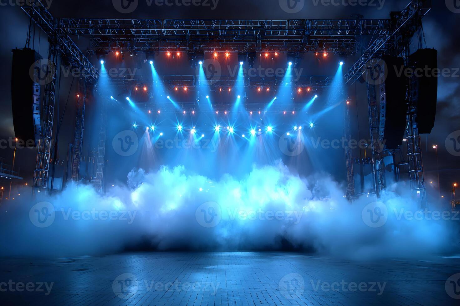 Free stage with spotlights and smoke illuminating night sky photo
