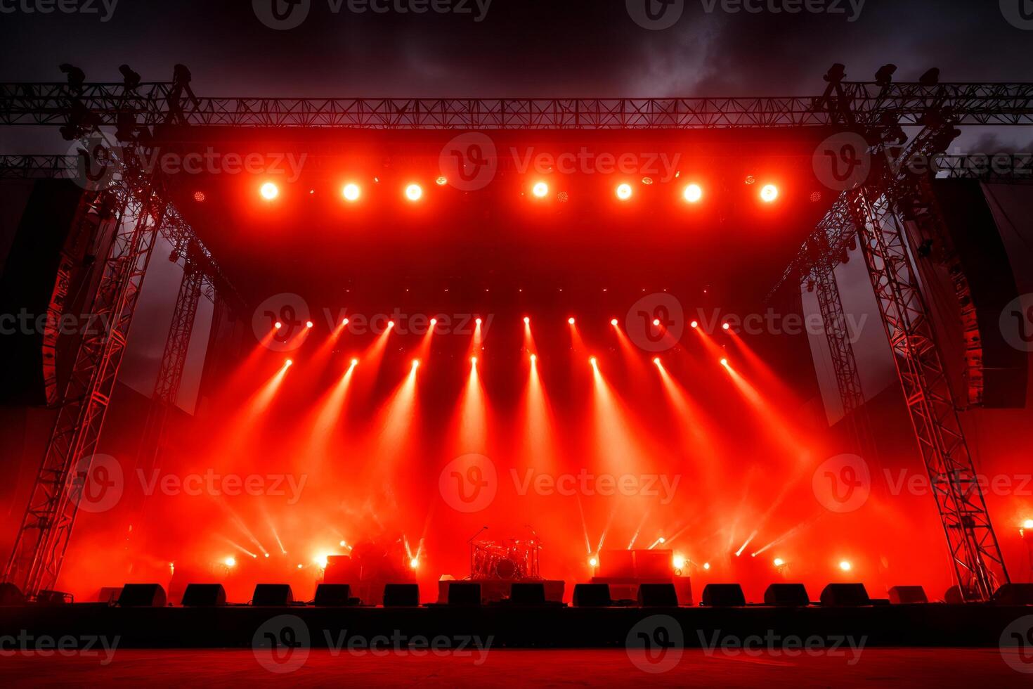 Red stage lights illuminating empty concert stage at night photo