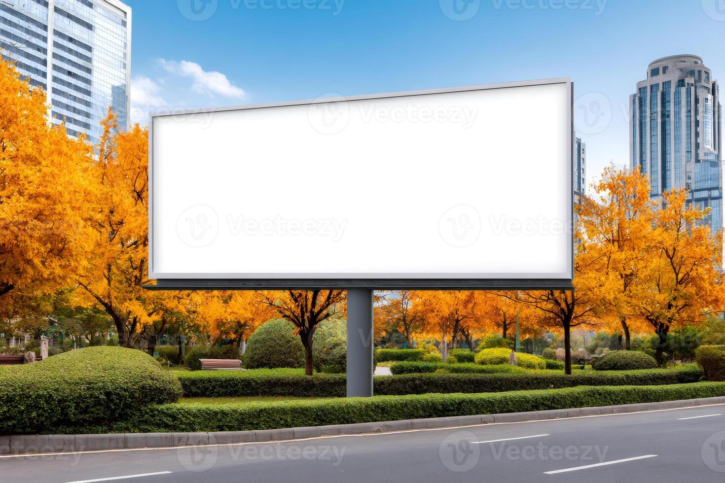 Large blank billboard displaying advertising space in an autumnal cityscape photo