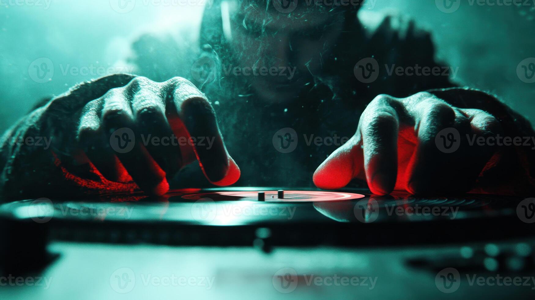 DJ focused on vinyl records in a dimly lit room creating an immersive atmosphere during a late-night music session photo