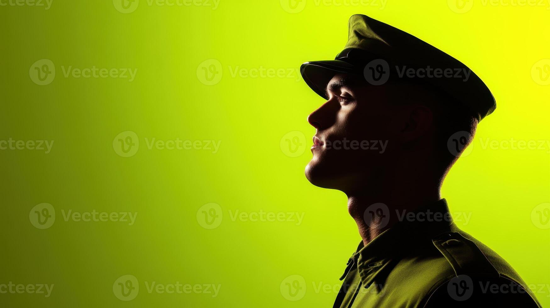 Profile of a military officer against a vibrant green background during sunset capturing the essence of duty and honor in uniform photo