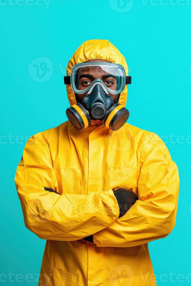 Person wearing a yellow protective suit and a gas mask, posing confidently against a bright blue background photo
