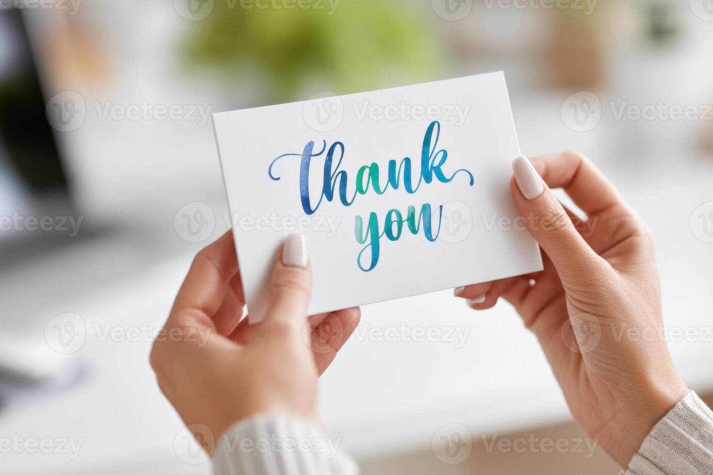 Hands holding a vibrant thank you card representing appreciation and recognition photo